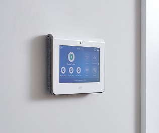 ADT Command Panel An ADT security touchscreen panel mounted on a wall, displaying system status and smart controls for business security.